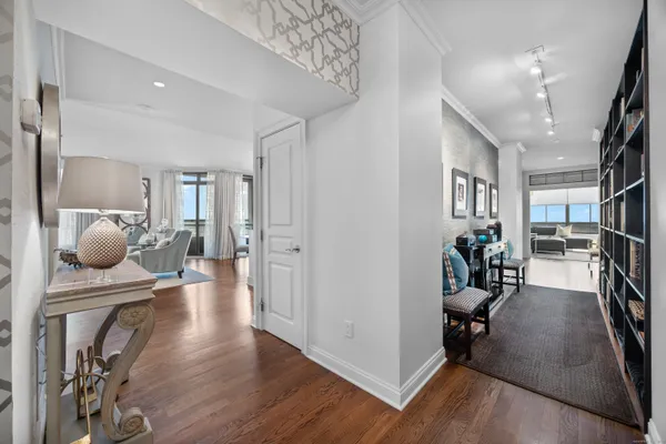 a living room with furniture and a wooden floor