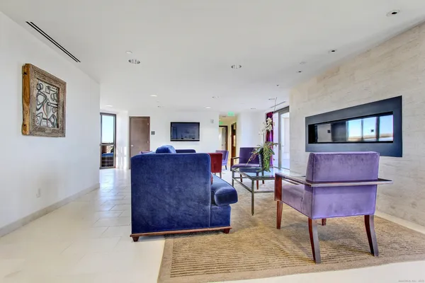 a room with wooden floor and large windows