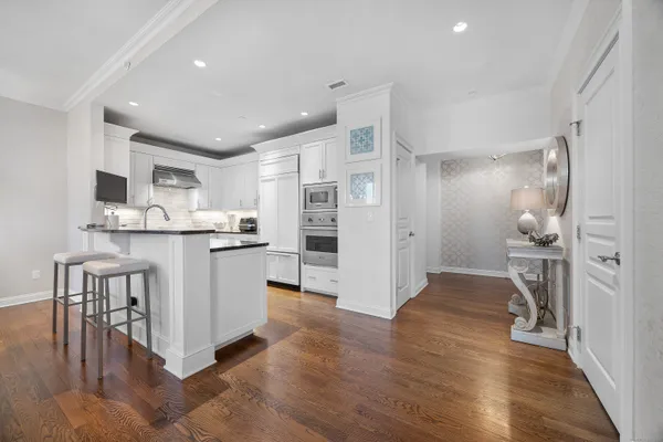 a kitchen with white cabinets and stainless steel appliances