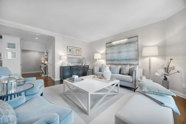 a living room with furniture and a large mirror