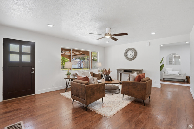 6889 South Village Road Salt Lake City, UT 84121 - Photo 6 of 44 Spacious living area featuring wood-finish flooring, a ceiling fan, recessed lighting, and a large picture window