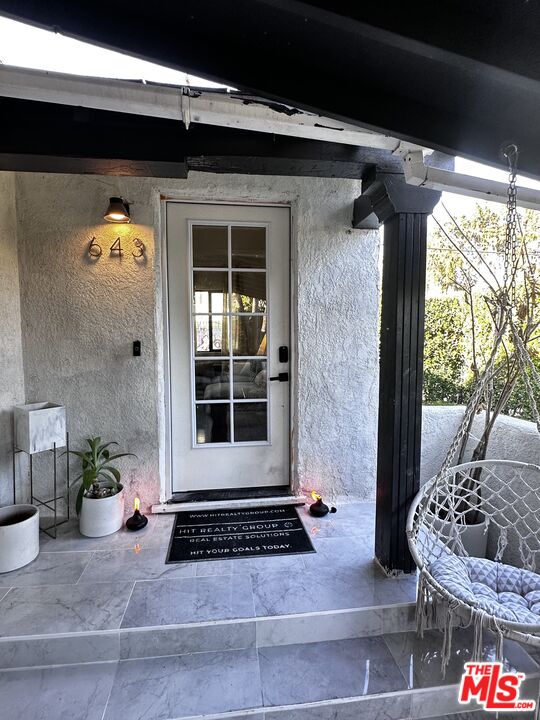 643 North Vista Street Los Angeles, CA 90036 - Photo 15 of 51 a front view of a house with a potted plant and floor to ceiling window