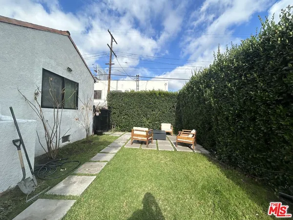 a backyard of a house with outdoor seating