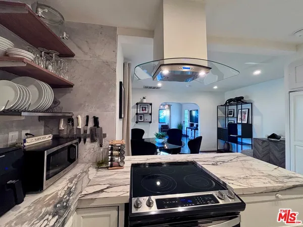 a kitchen with a stove and a refrigerator