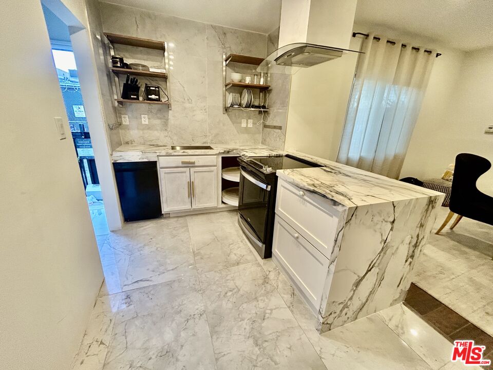 643 North Vista Street Los Angeles, CA 90036 - Photo 4 of 51 a kitchen with a stove a sink and a refrigerator