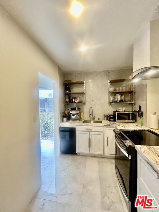 643 North Vista Street Los Angeles, CA 90036 - Photo 5 of 51 a kitchen with stainless steel appliances granite countertop a sink and cabinets