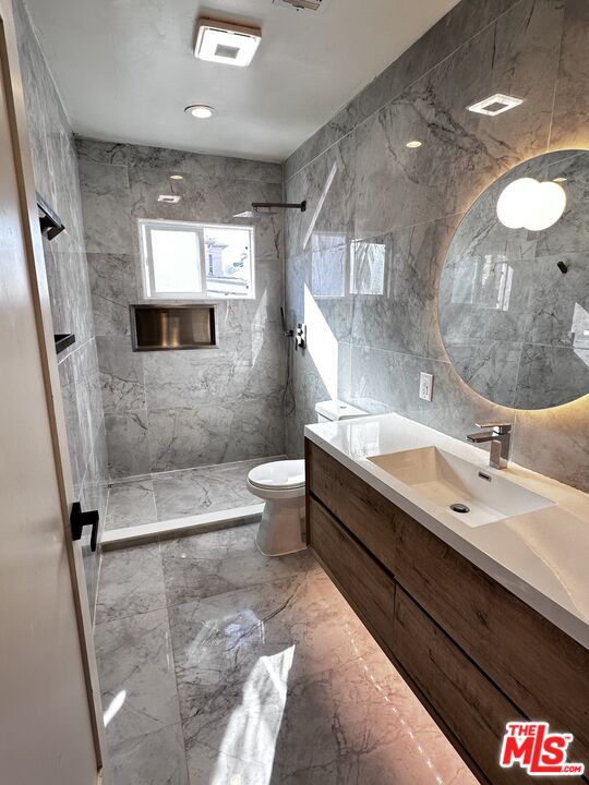 643 North Vista Street Los Angeles, CA 90036 - Photo 8 of 51 a bathroom with a double vanity sink toilet mirror and bathtub