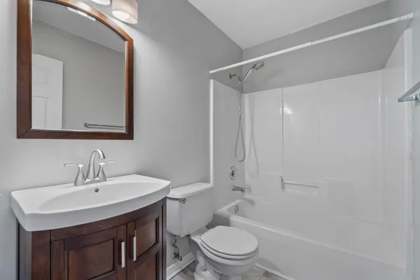 a bathroom with a sink toilet vanity and shower