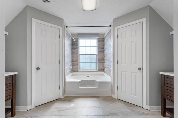 a bathroom with a bathtub and a sink