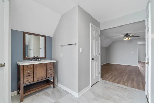 a view of a bathroom with a tub shower vanity and a sink
