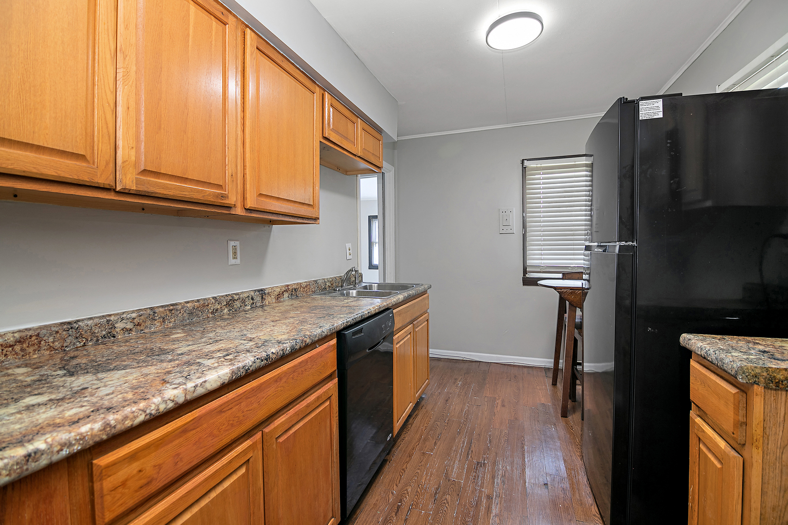 729 Webster Circle West Kankakee, IL 60901 - Photo 4 of 16 a kitchen with granite countertop a sink a stove refrigerator and cabinets
