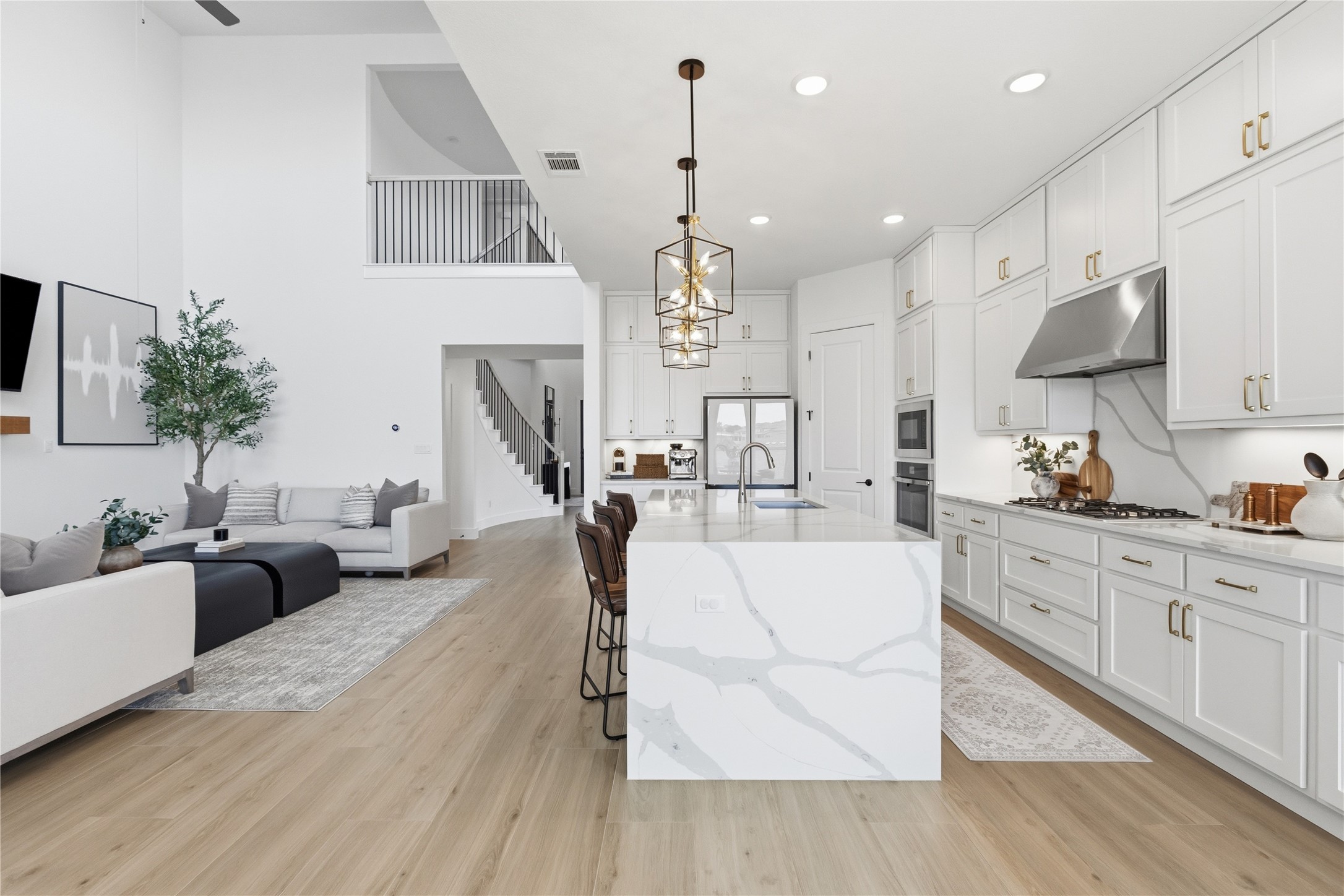 836 Villa Rialto View Leander, TX 78641 - Photo 12 of 33 An open-concept living space boasts a gourmet kitchen with a spacious island, perfect for entertaining.