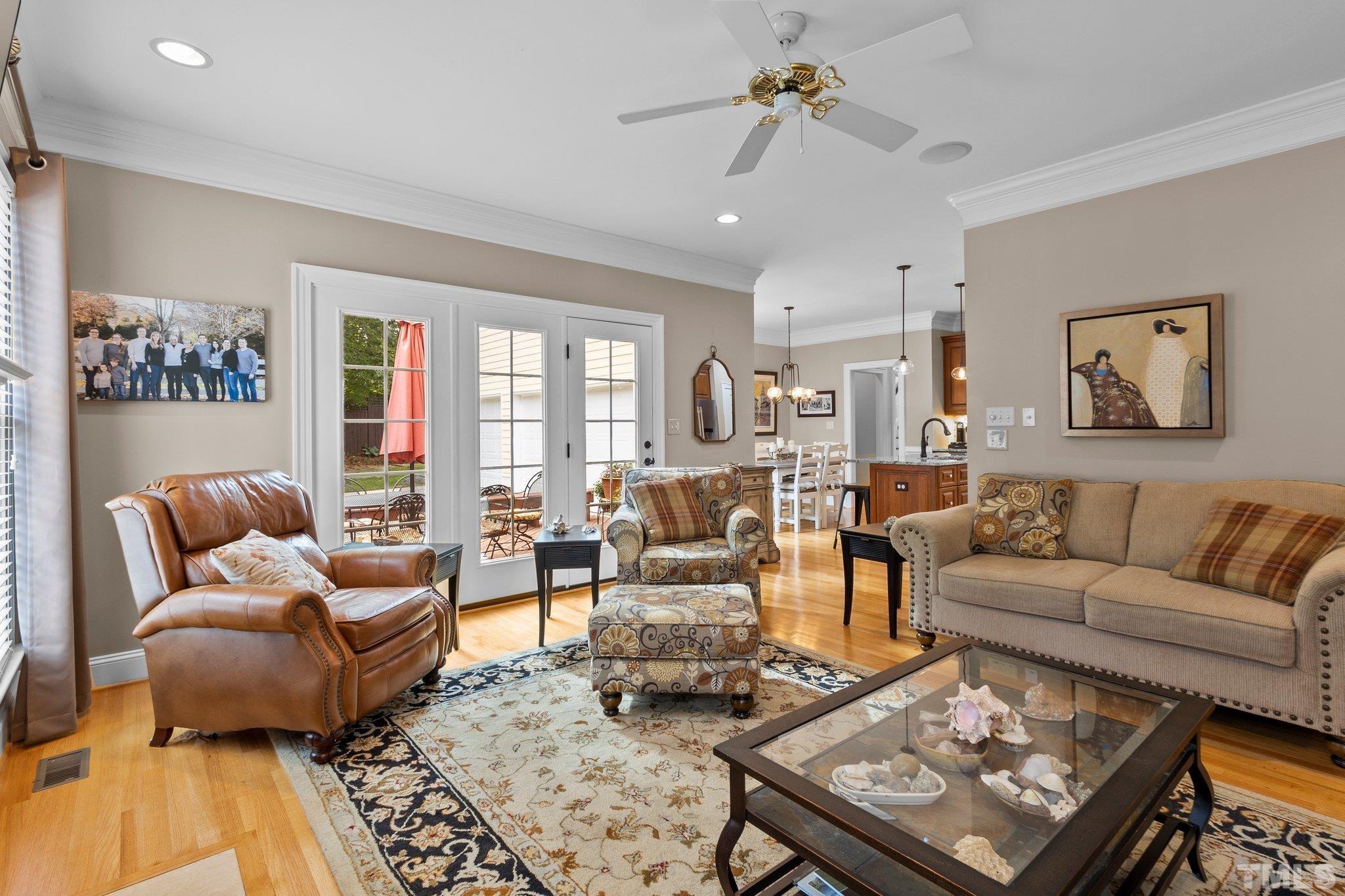 3205 Tall Tree Place Raleigh, NC 27607 - Photo 18 of 58 a living room with furniture a rug and a chandelier