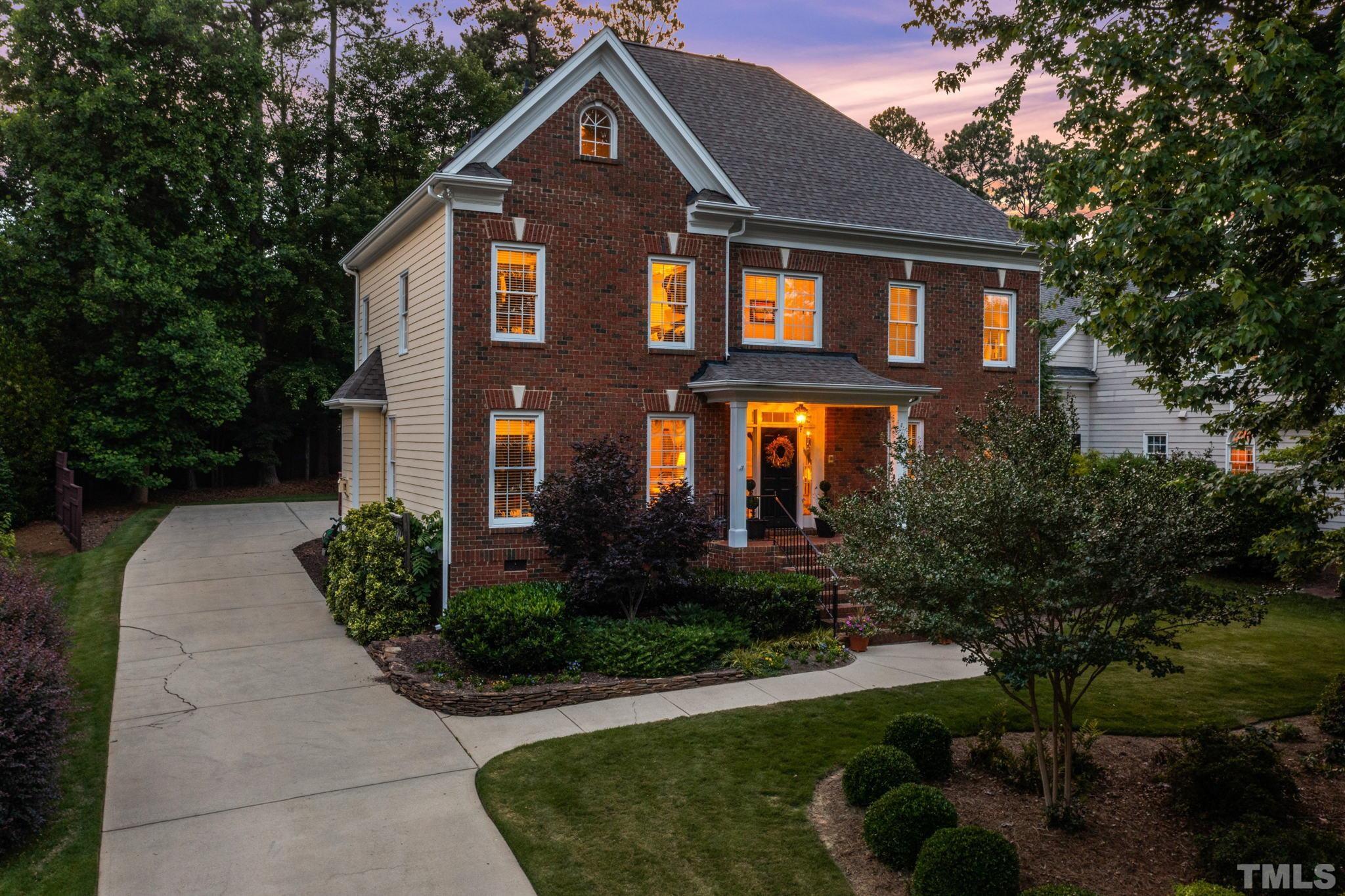 3205 Tall Tree Place Raleigh, NC 27607 - Photo 2 of 58 a front view of a house with garden