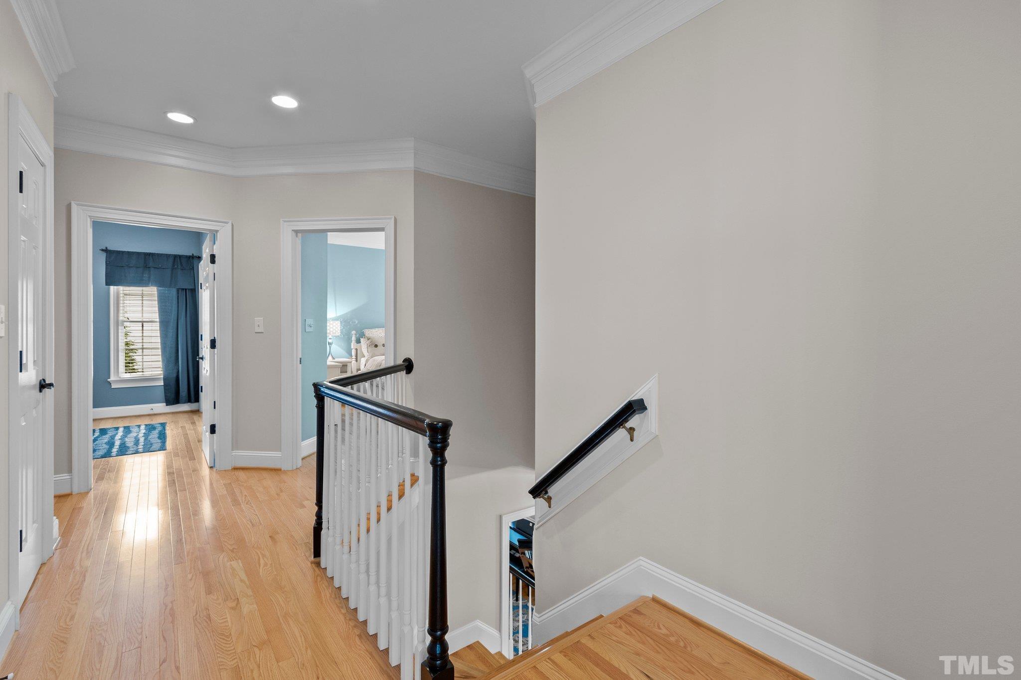 3205 Tall Tree Place Raleigh, NC 27607 - Photo 21 of 58 a view of a hallway with wooden floor and staircase