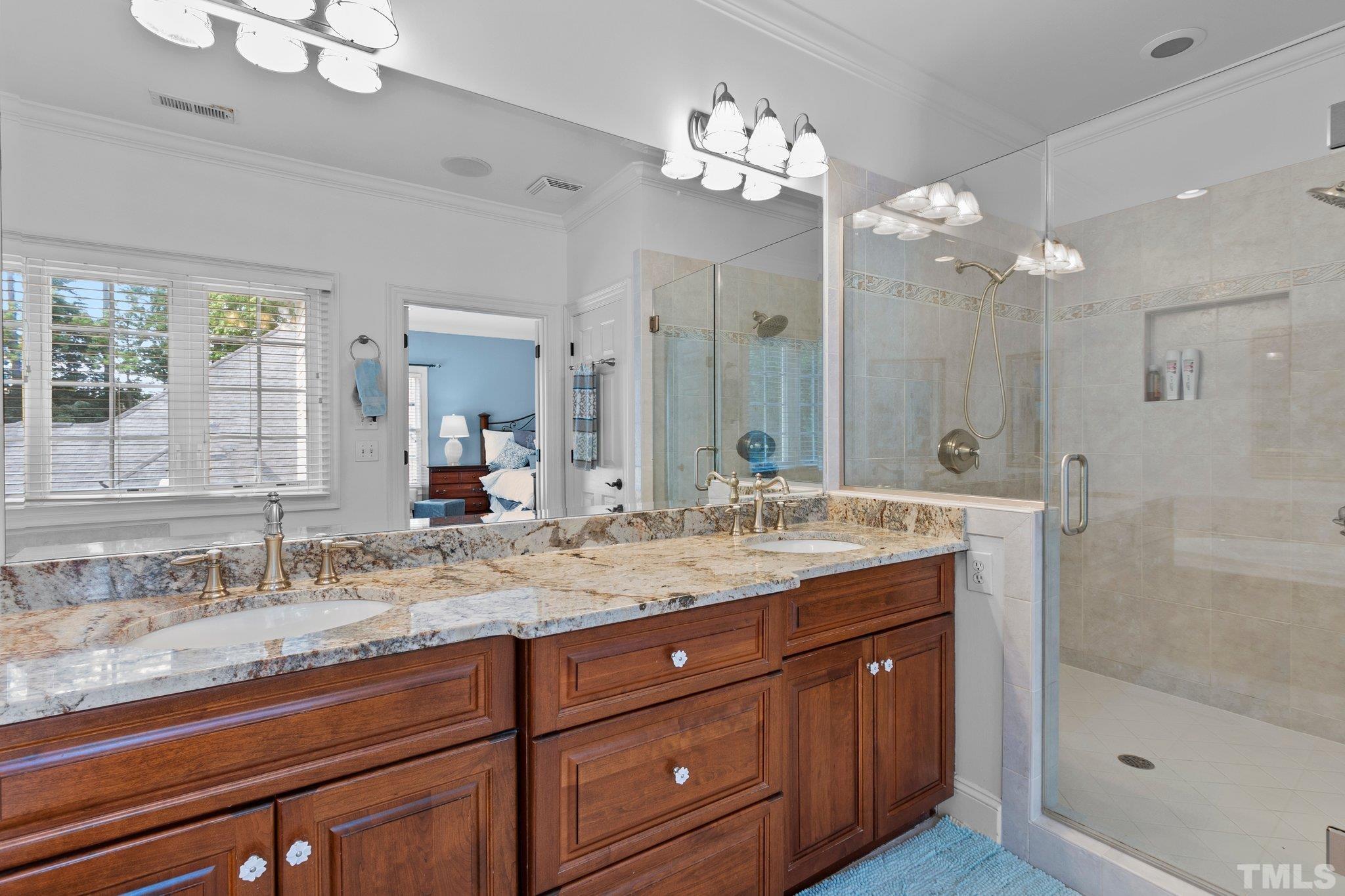 3205 Tall Tree Place Raleigh, NC 27607 - Photo 26 of 58 a bathroom with a granite countertop double vanity sink and a mirror