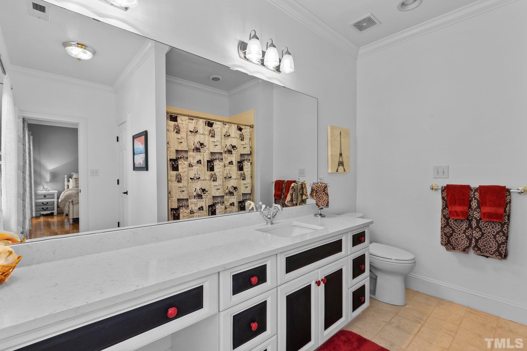 3205 Tall Tree Place Raleigh, NC 27607 - Photo 30 of 58 a spacious bathroom with a double vanity sink toilet and shower
