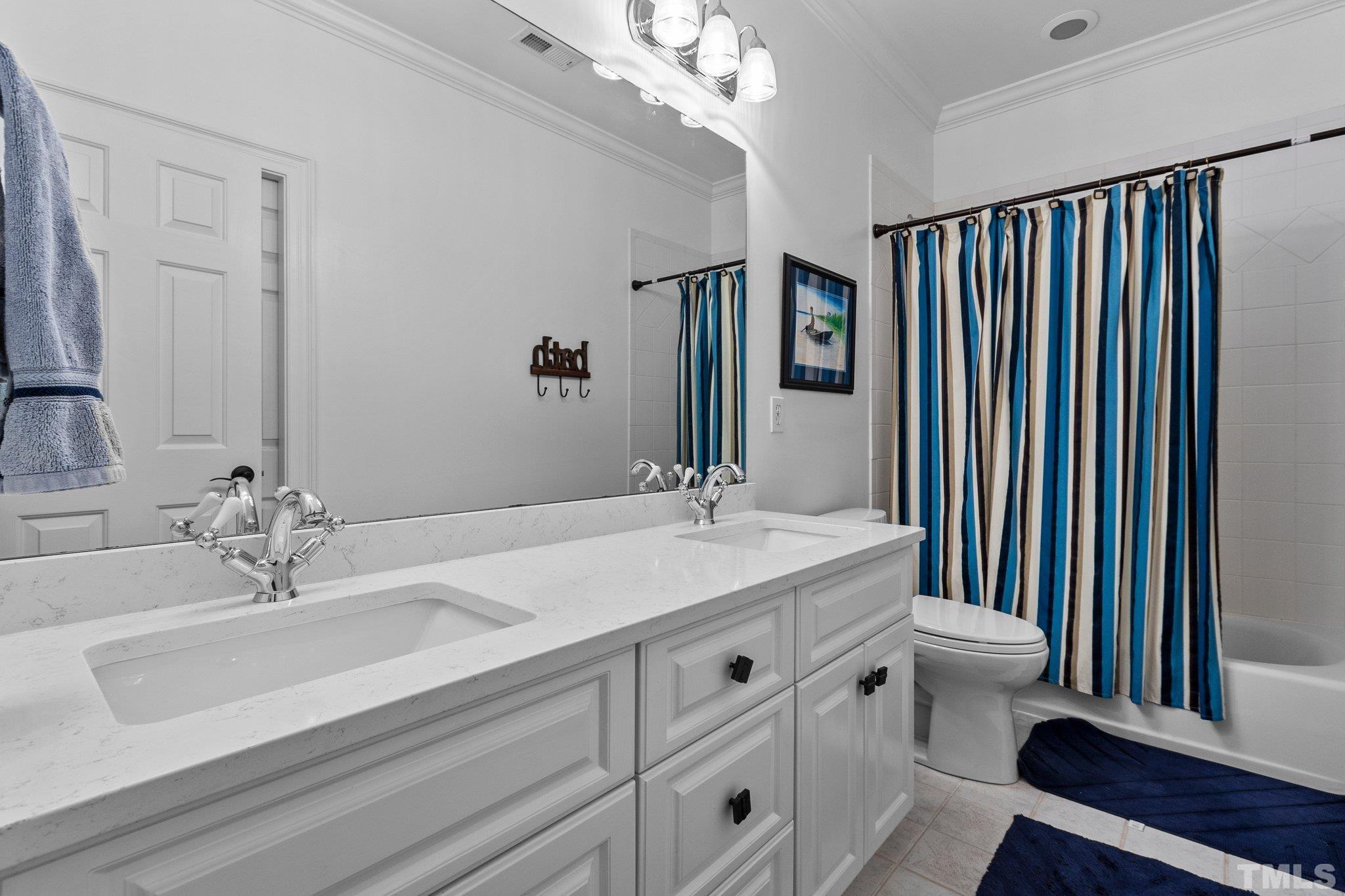 3205 Tall Tree Place Raleigh, NC 27607 - Photo 32 of 58 a bathroom with a sink and a mirror