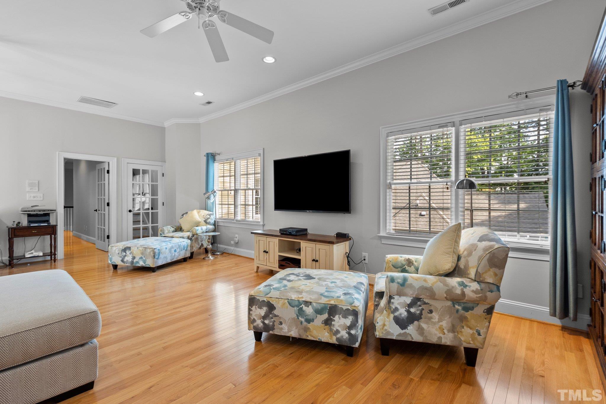 3205 Tall Tree Place Raleigh, NC 27607 - Photo 36 of 58 a living room with furniture and a flat screen tv