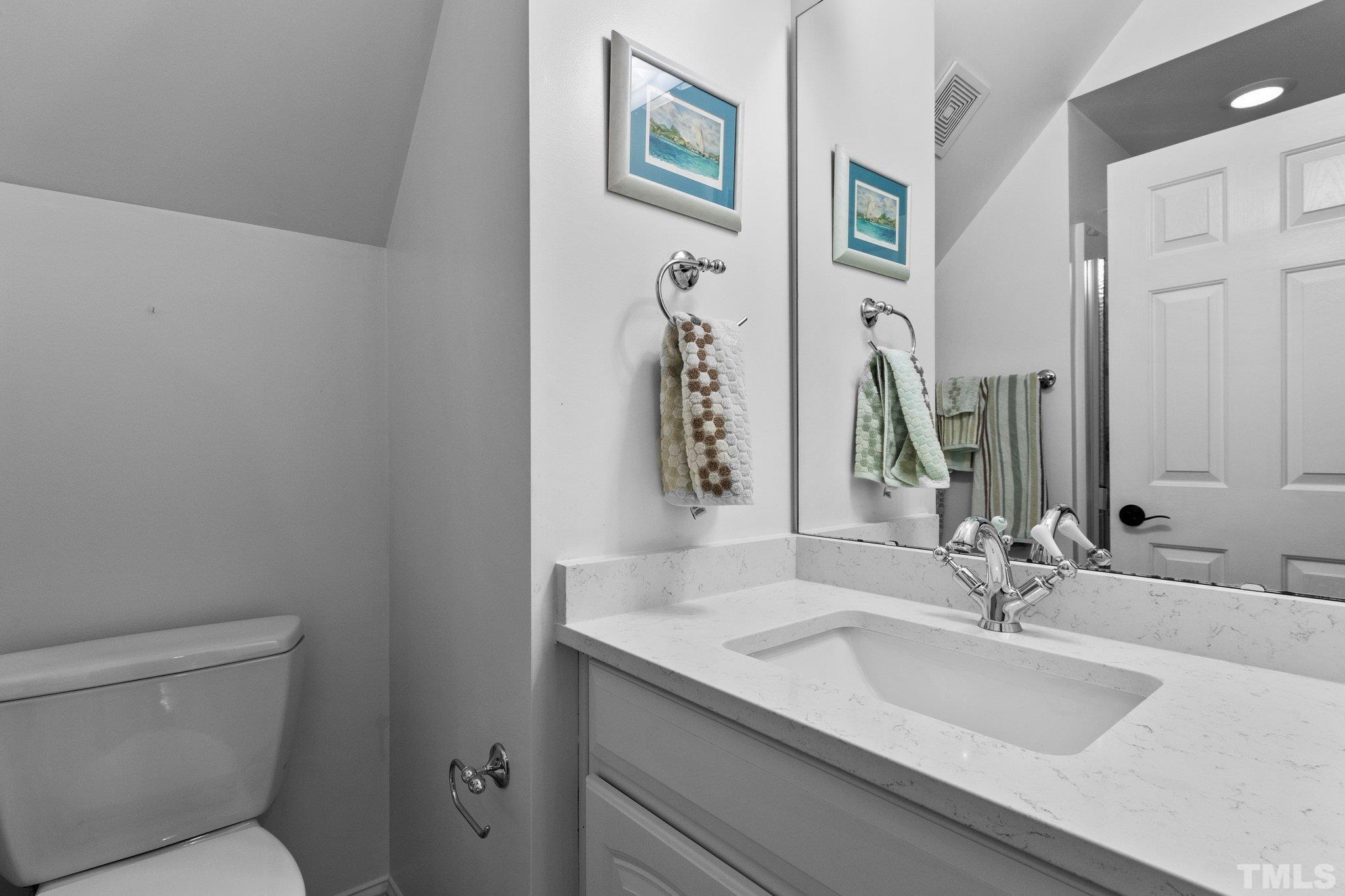 3205 Tall Tree Place Raleigh, NC 27607 - Photo 39 of 58 a bathroom with a granite countertop sink and a mirror