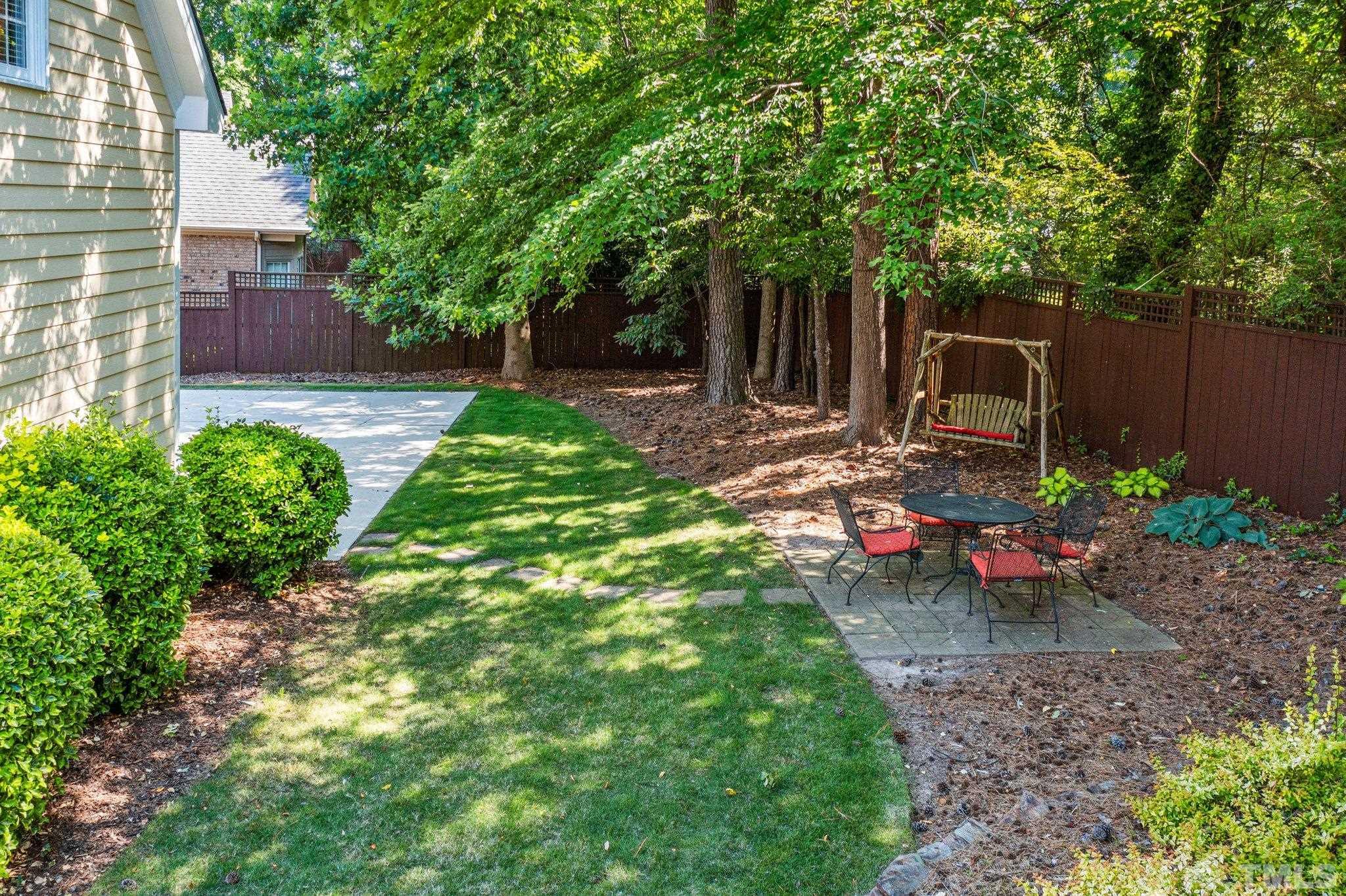 3205 Tall Tree Place Raleigh, NC 27607 - Photo 46 of 58 a view of a backyard with chair and table