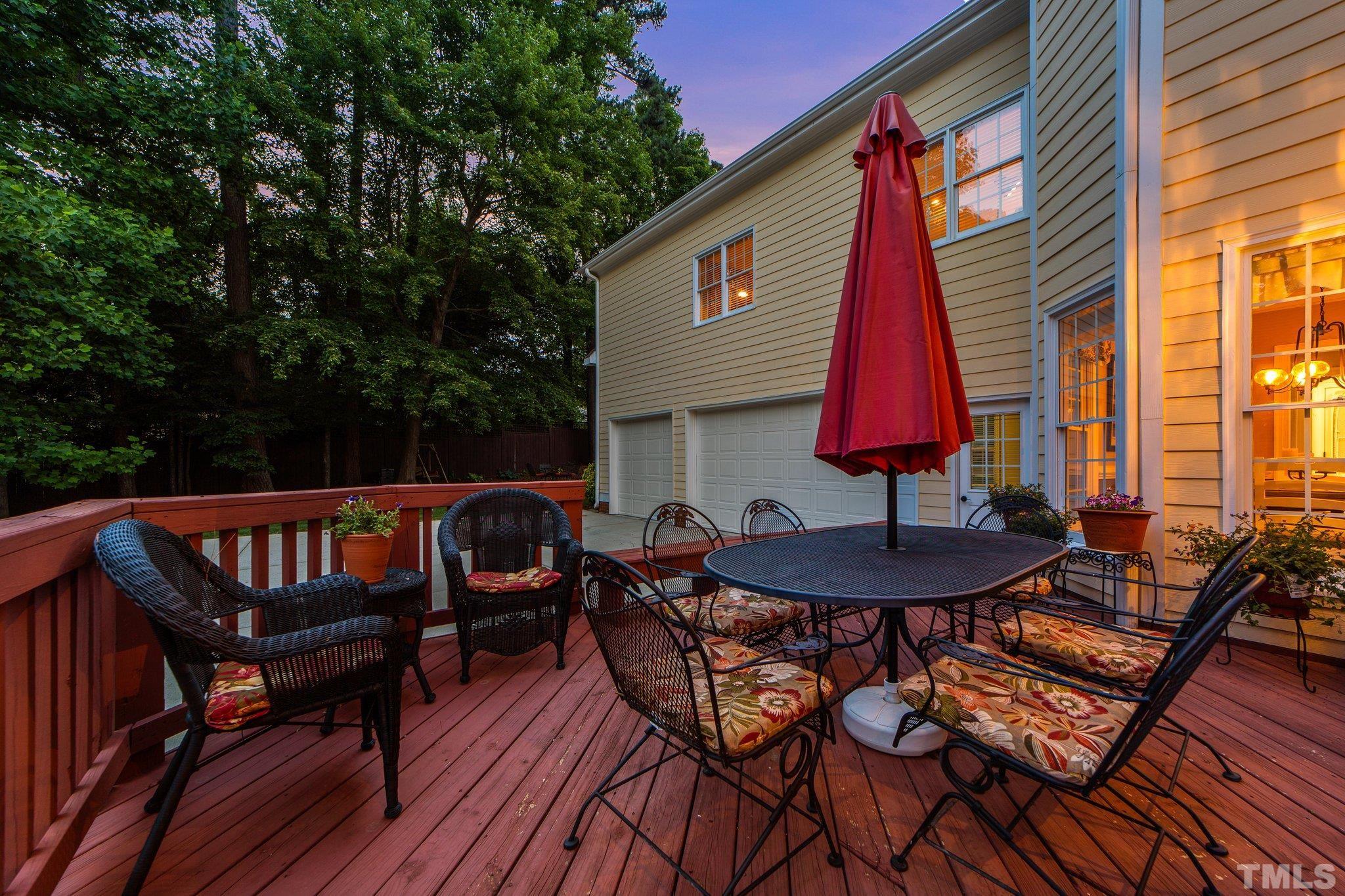 3205 Tall Tree Place Raleigh, NC 27607 - Photo 52 of 58 a view of balcony with a dining table and chairs with wooden floor and fence