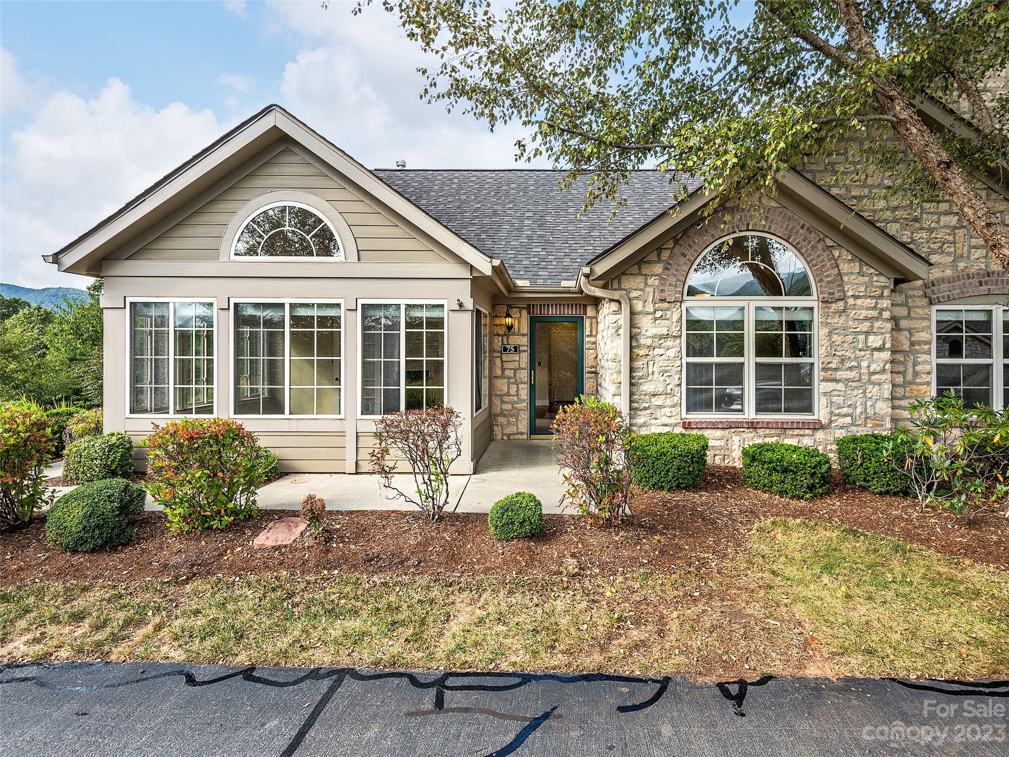 a front view of a house with garden