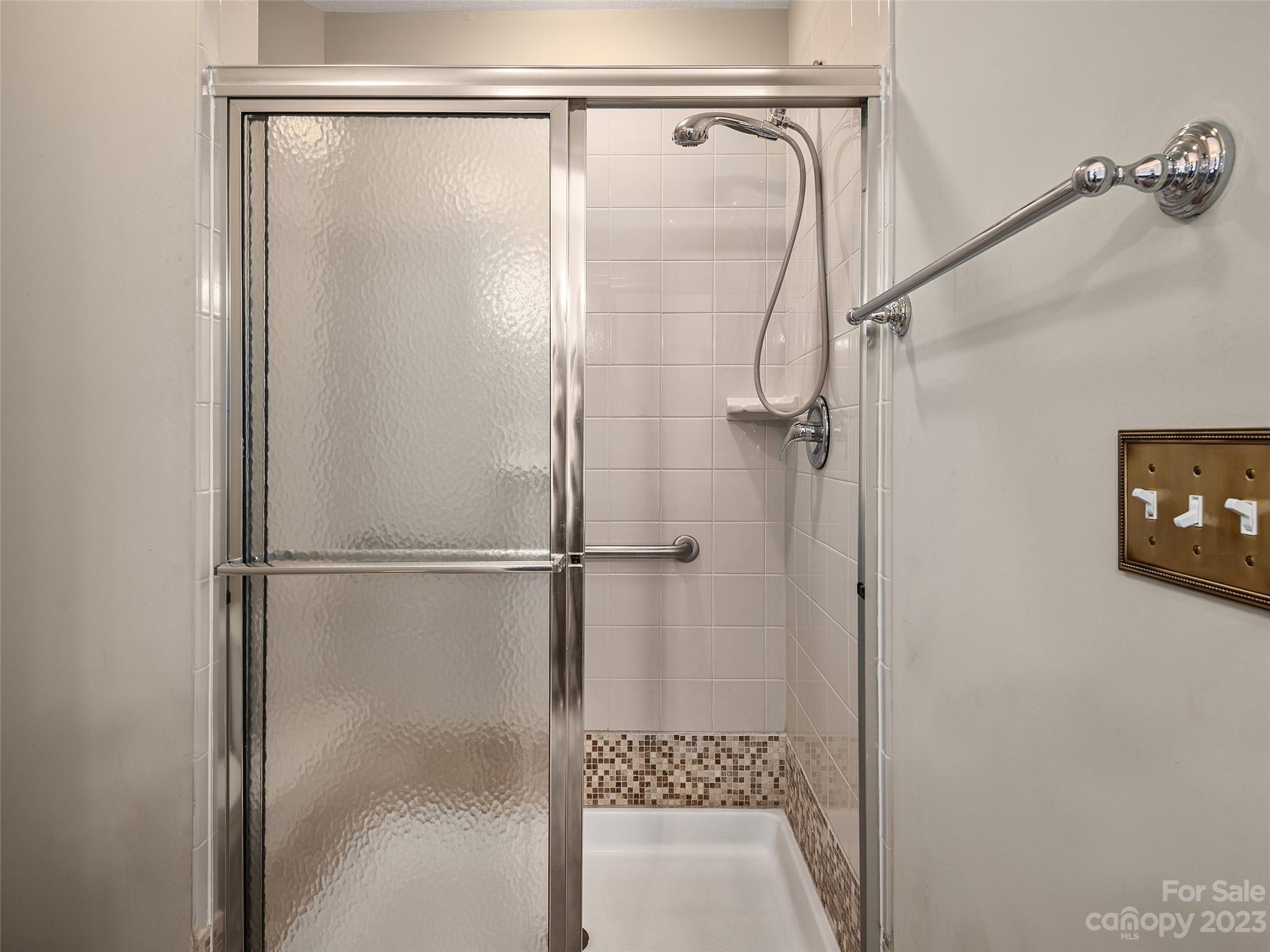 75 Outlook Circle Swannanoa, NC 28778 - Photo 11 of 31 a bathroom with a glass shower door