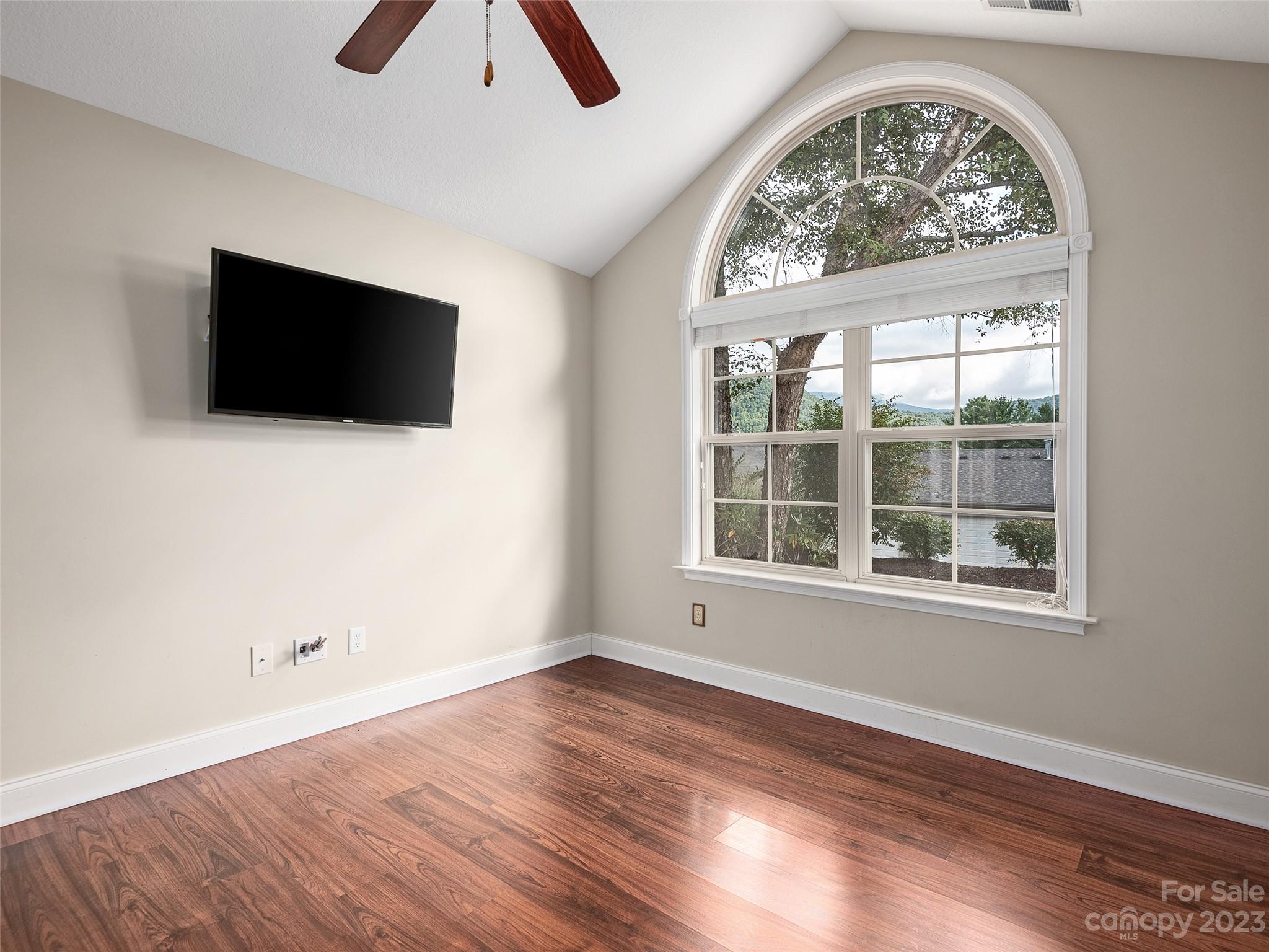 75 Outlook Circle Swannanoa, NC 28778 - Photo 13 of 31 an empty room with wooden floor and windows