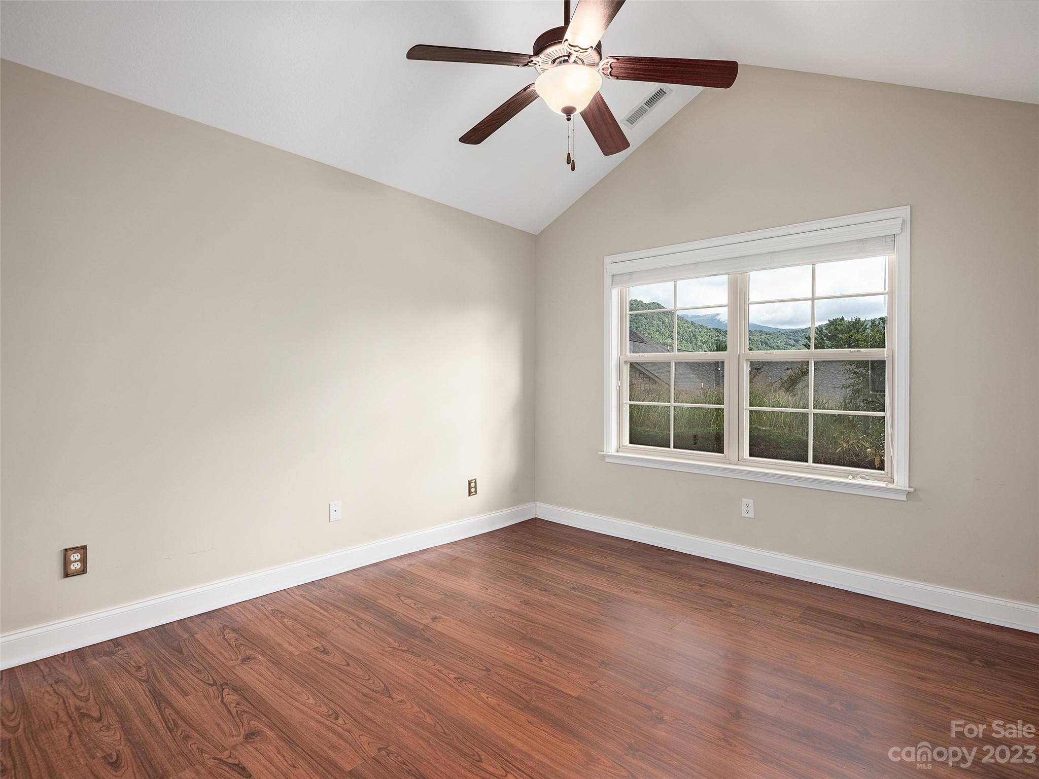 75 Outlook Circle Swannanoa, NC 28778 - Photo 14 of 31 an empty room with wooden floor fan and windows