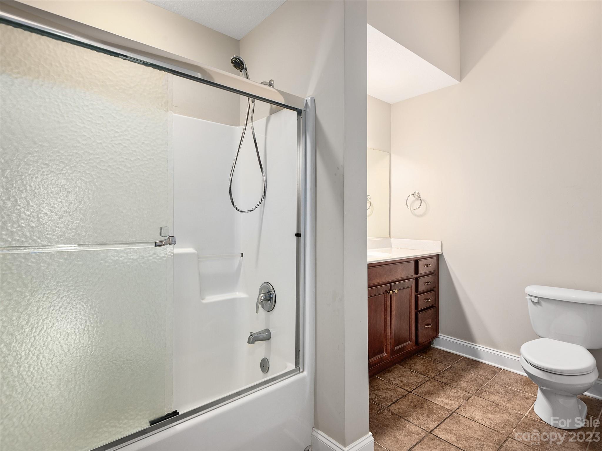 75 Outlook Circle Swannanoa, NC 28778 - Photo 16 of 31 a bathroom with a granite countertop shower a toilet and a sink