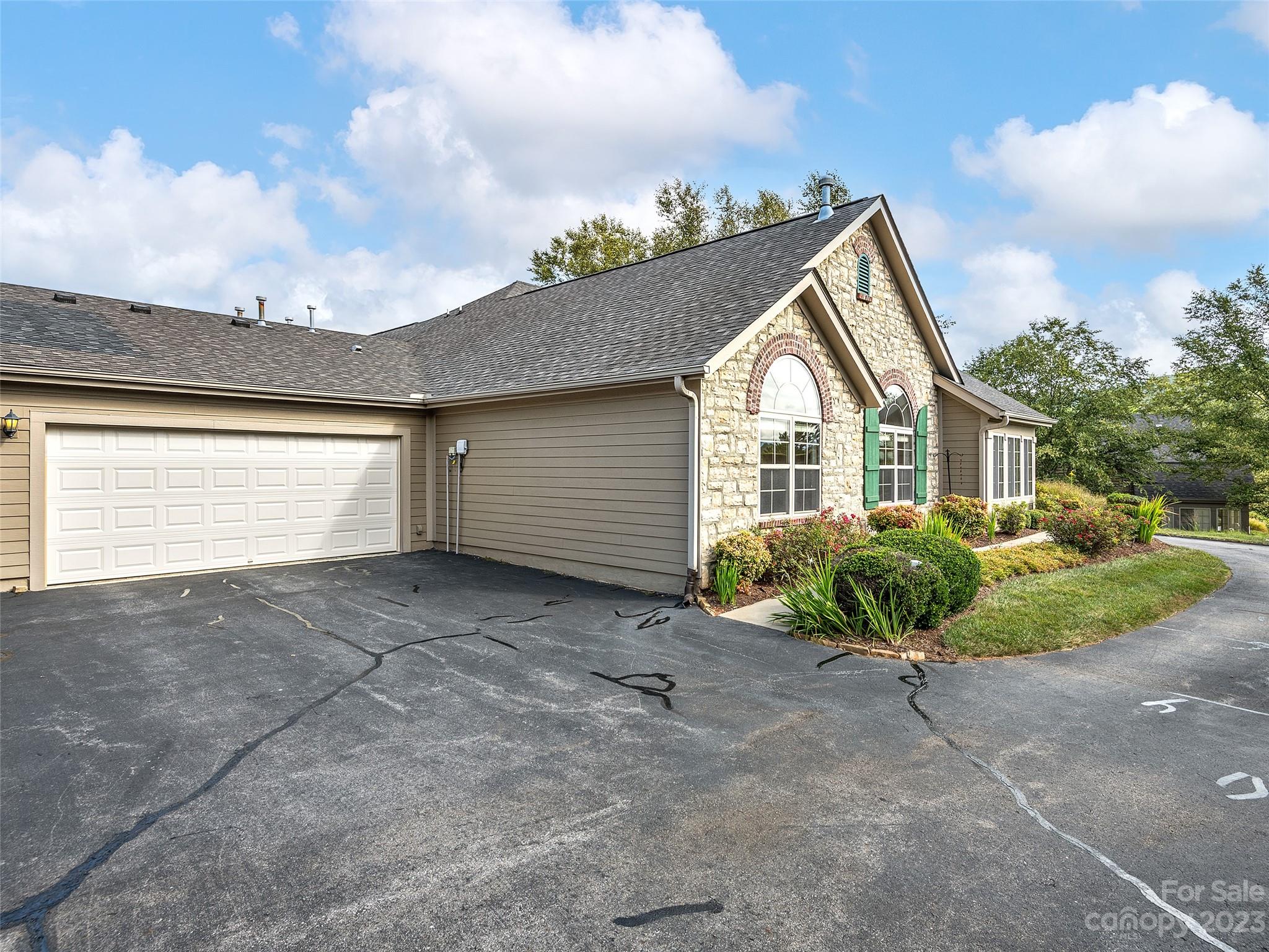 75 Outlook Circle Swannanoa, NC 28778 - Photo 20 of 31 a view of a house with a yard and garage