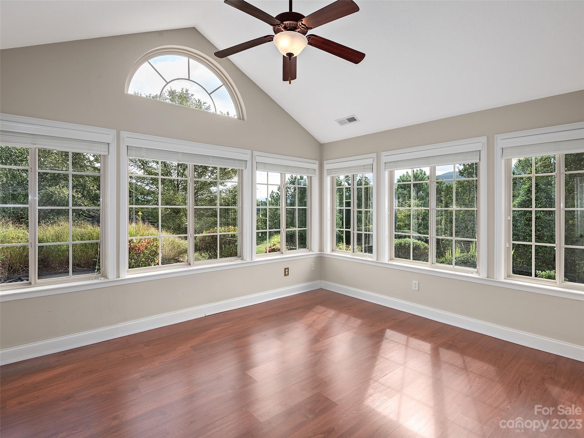 75 Outlook Circle Swannanoa, NC 28778 - Photo 4 of 31 a view of an empty room with a window and wooden floor