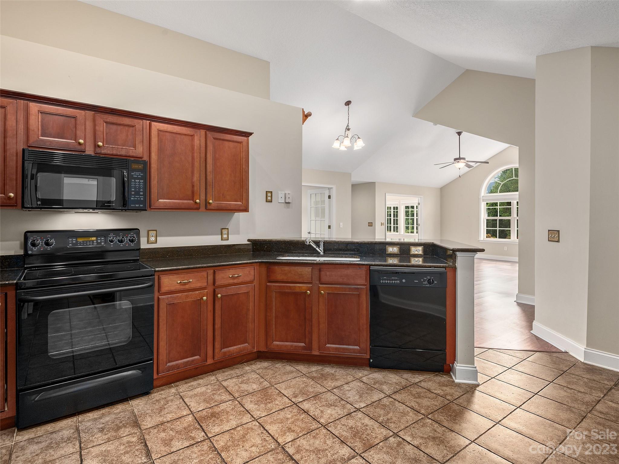 75 Outlook Circle Swannanoa, NC 28778 - Photo 7 of 31 a kitchen with stainless steel appliances granite countertop a stove a sink and a microwave