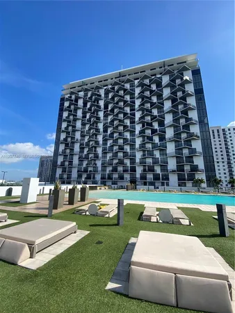 a view of a tall building with a yard