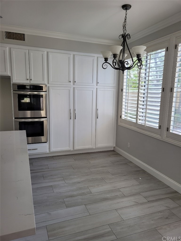 2 Belfort Newport Coast, CA 92657 - Photo 15 of 18 a view of a kitchen with a stove cabinets and wooden floor