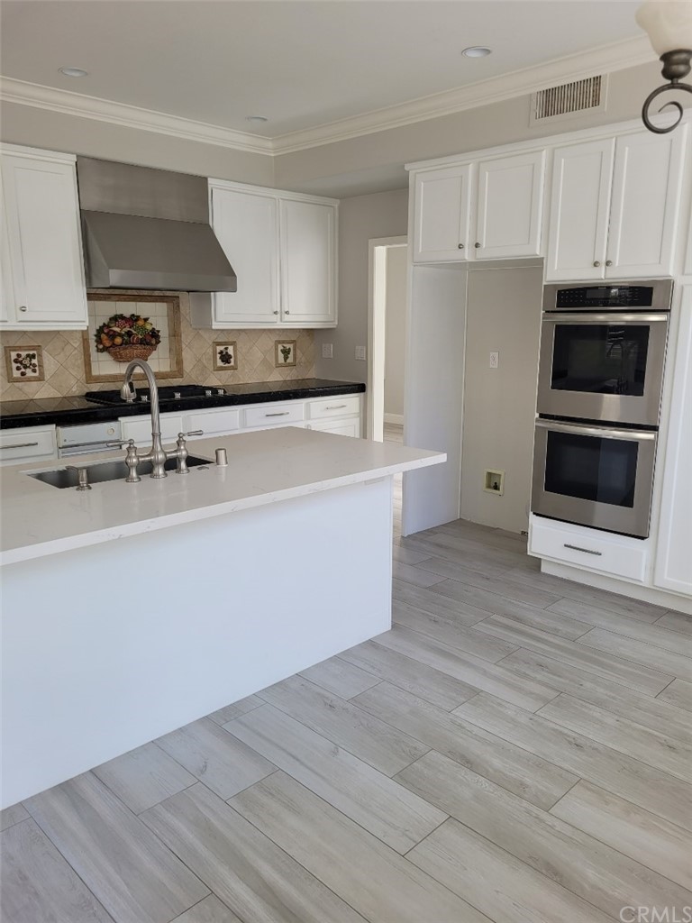 2 Belfort Newport Coast, CA 92657 - Photo 16 of 18 a kitchen with stainless steel appliances a stove a sink and a microwave