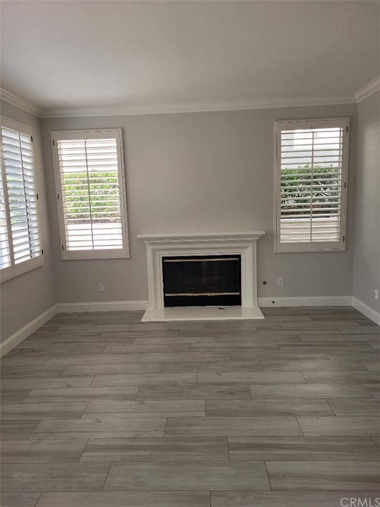 2 Belfort Newport Coast, CA 92657 - Photo 3 of 18 a view of an empty room with wooden floor and a window