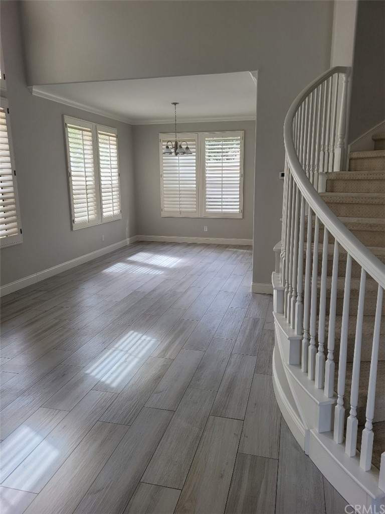 2 Belfort Newport Coast, CA 92657 - Photo 5 of 18 an empty room with wooden floor and windows