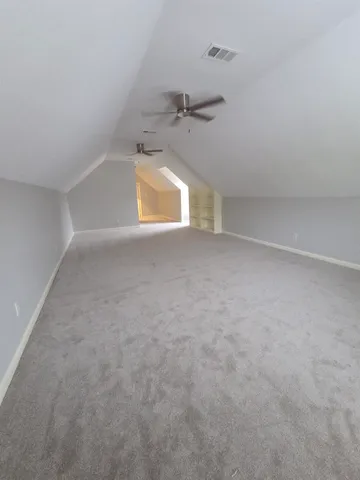 an empty room with a empty space and windows