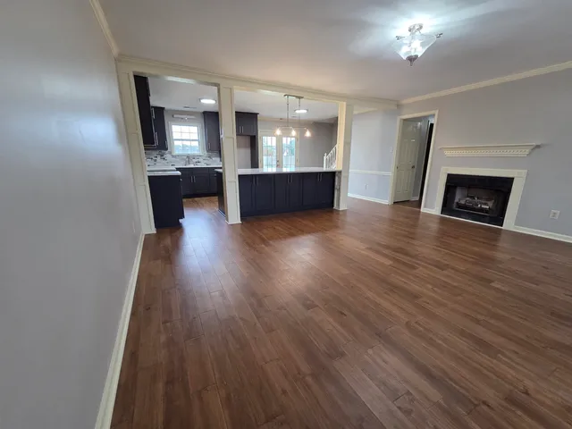 a view of kitchen and hall with wooden floor