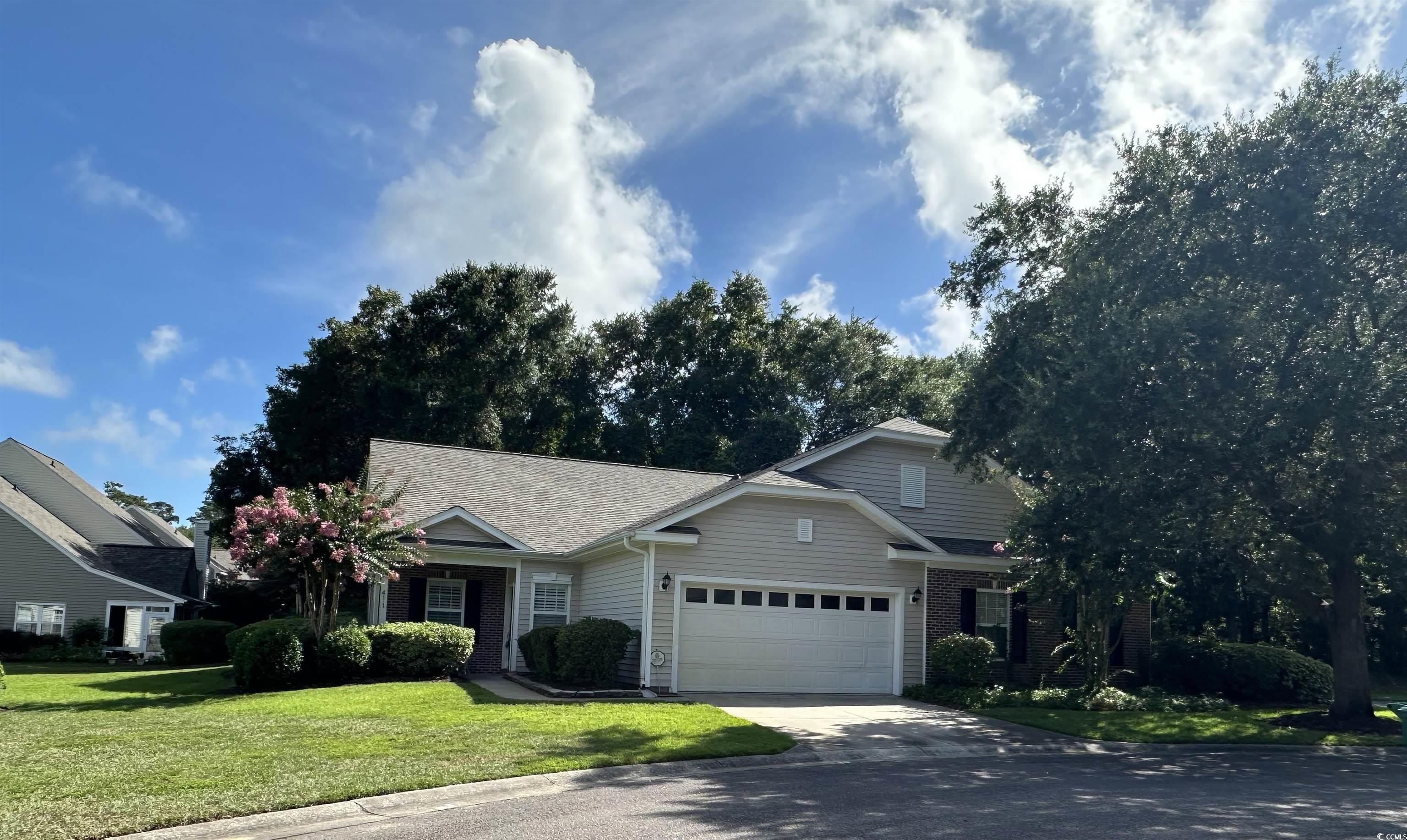 41 Rapture Court, Unit 1 Pawleys Island, SC 29585 - Photo 1 of 1 View of front facade featuring a garage, driveway,