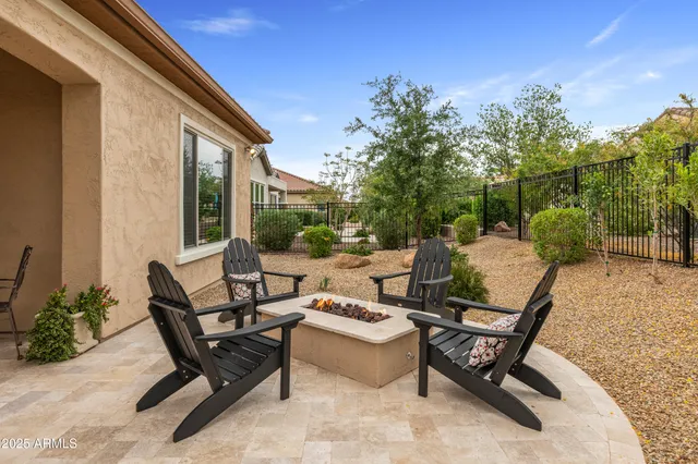a view of a patio with couches table and chairs and potted plants