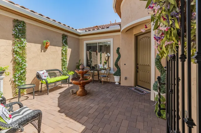 a view of a bedroom with a table and chairs in patio