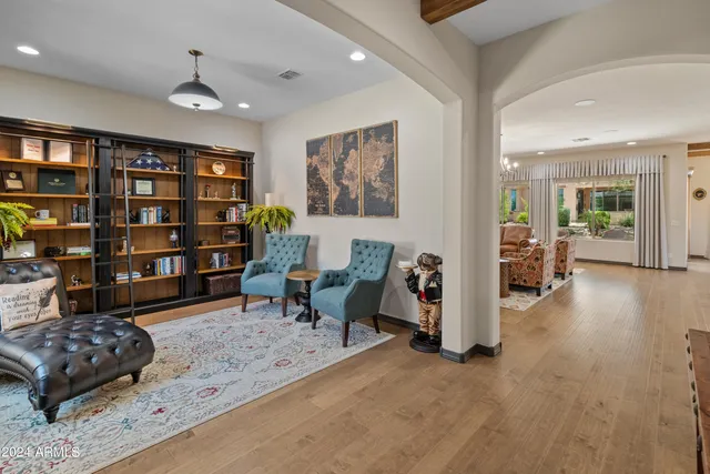 a living room with furniture and a book shelf
