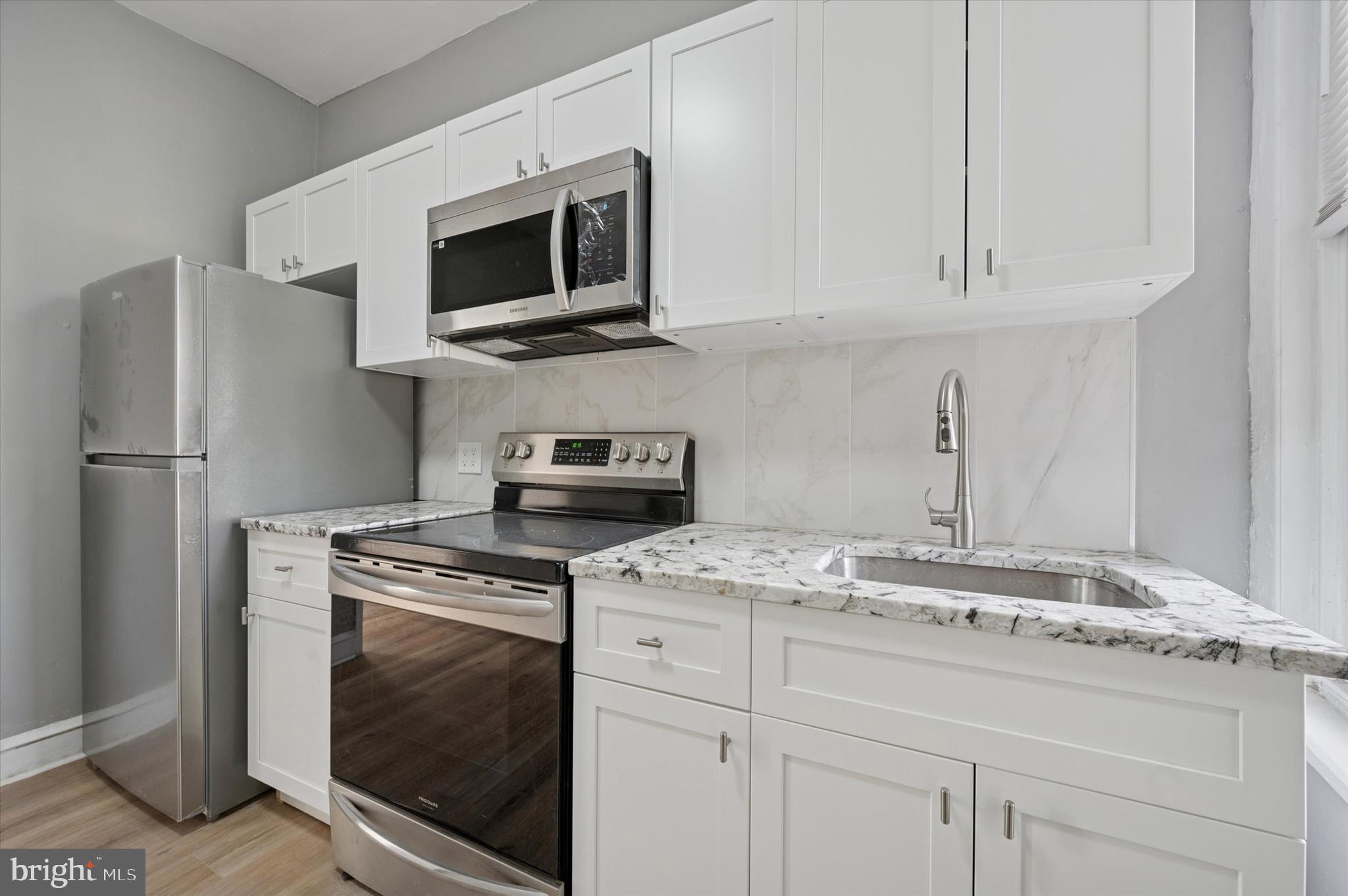 249 South 44th Street, Unit 4 Philadelphia, PA 19104 - Photo 15 of 25 a kitchen with cabinets stainless steel appliances and a sink