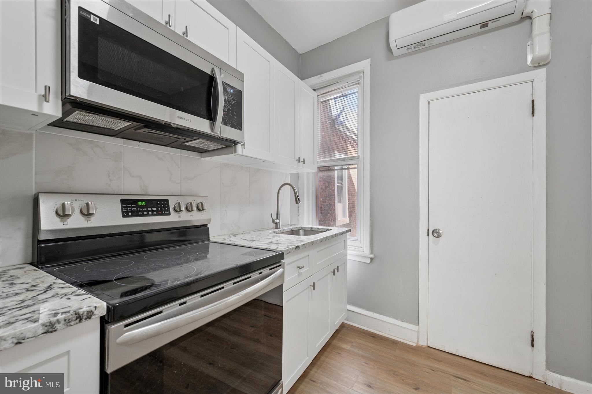 249 South 44th Street, Unit 4 Philadelphia, PA 19104 - Photo 16 of 25 a kitchen with stainless steel appliances a stove microwave and sink