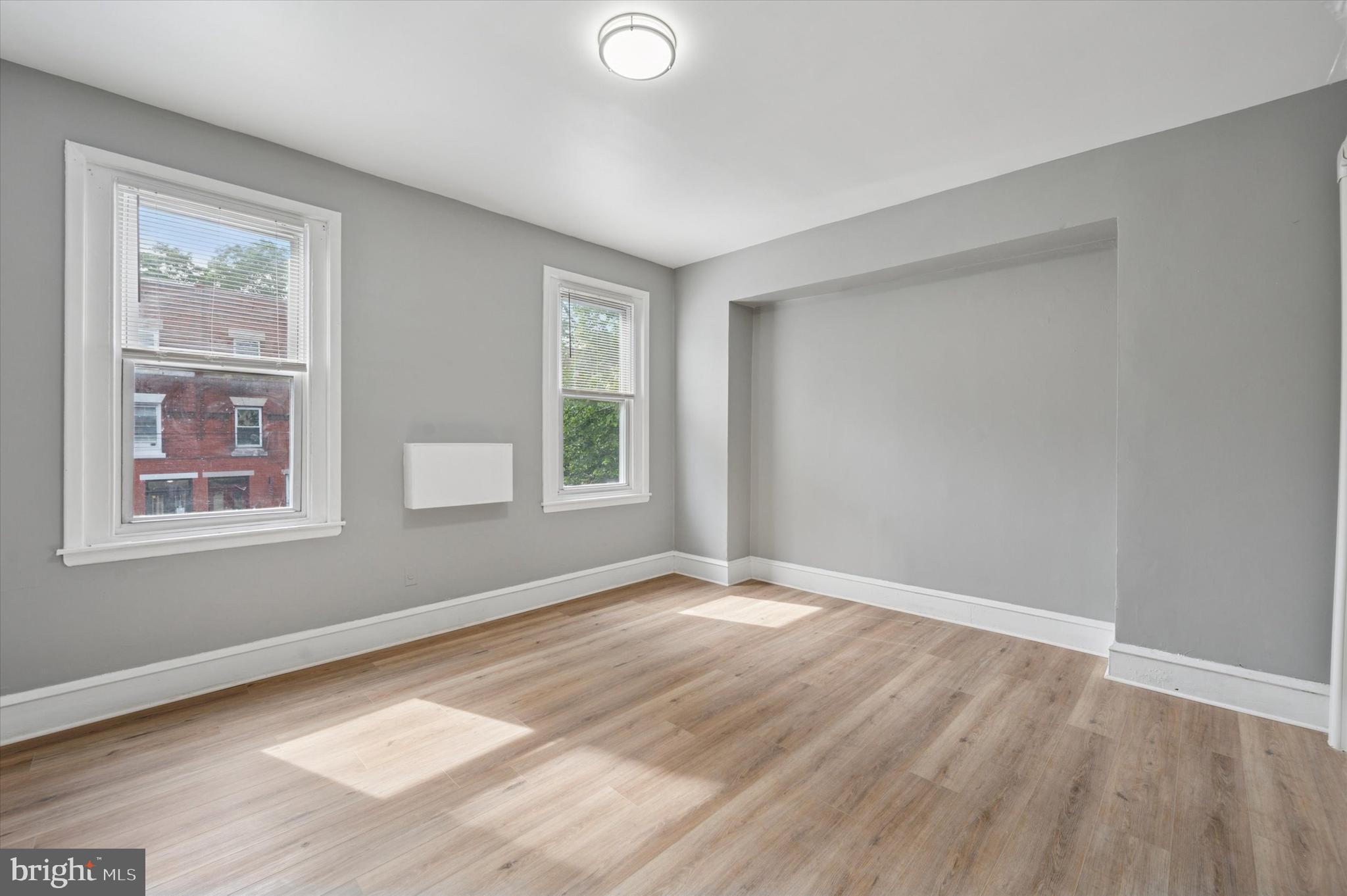 249 South 44th Street, Unit 4 Philadelphia, PA 19104 - Photo 17 of 25 a view of an empty room with wooden floor and a window