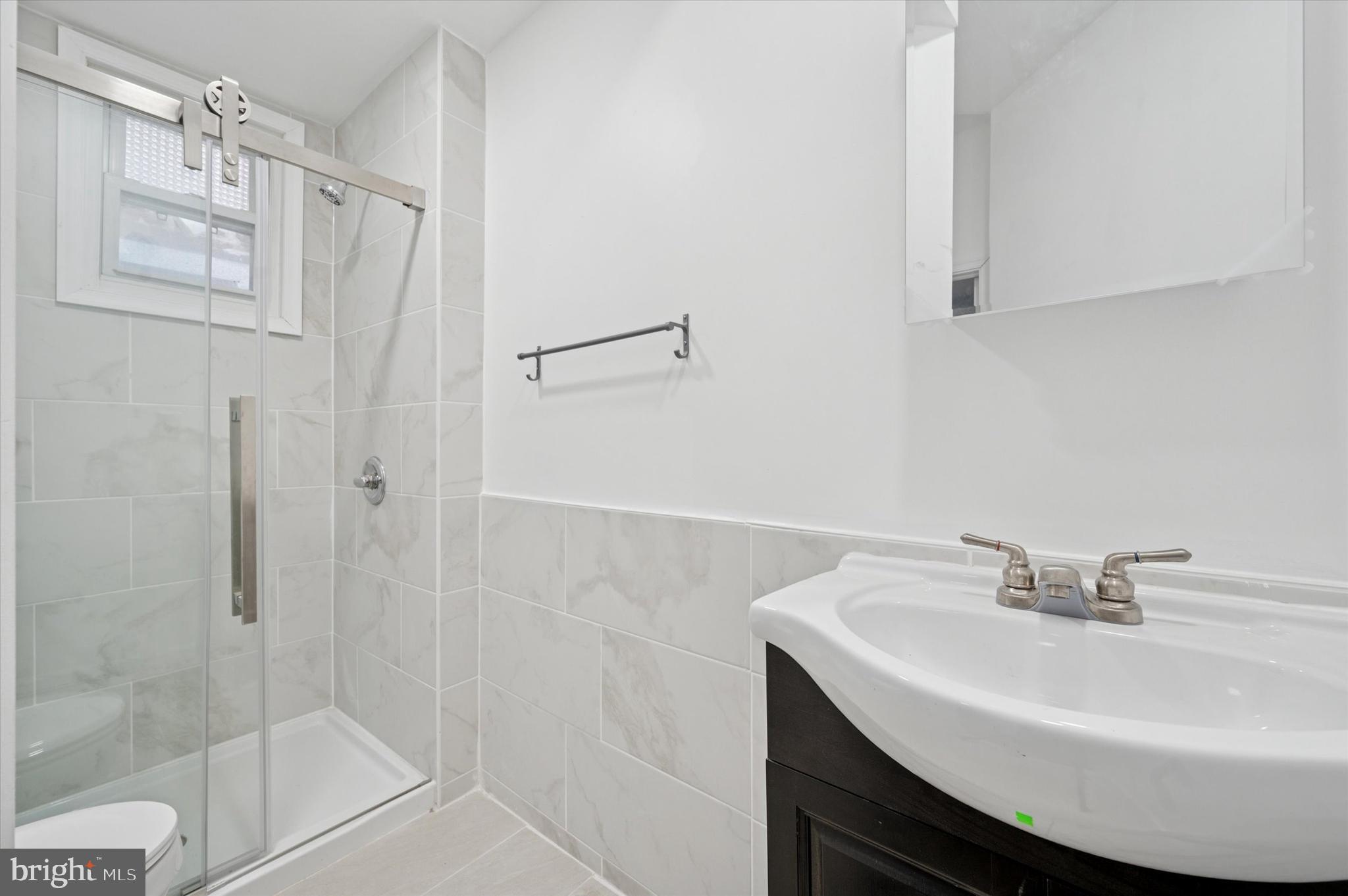 249 South 44th Street, Unit 4 Philadelphia, PA 19104 - Photo 23 of 25 a bathroom with a sink shower and a mirror