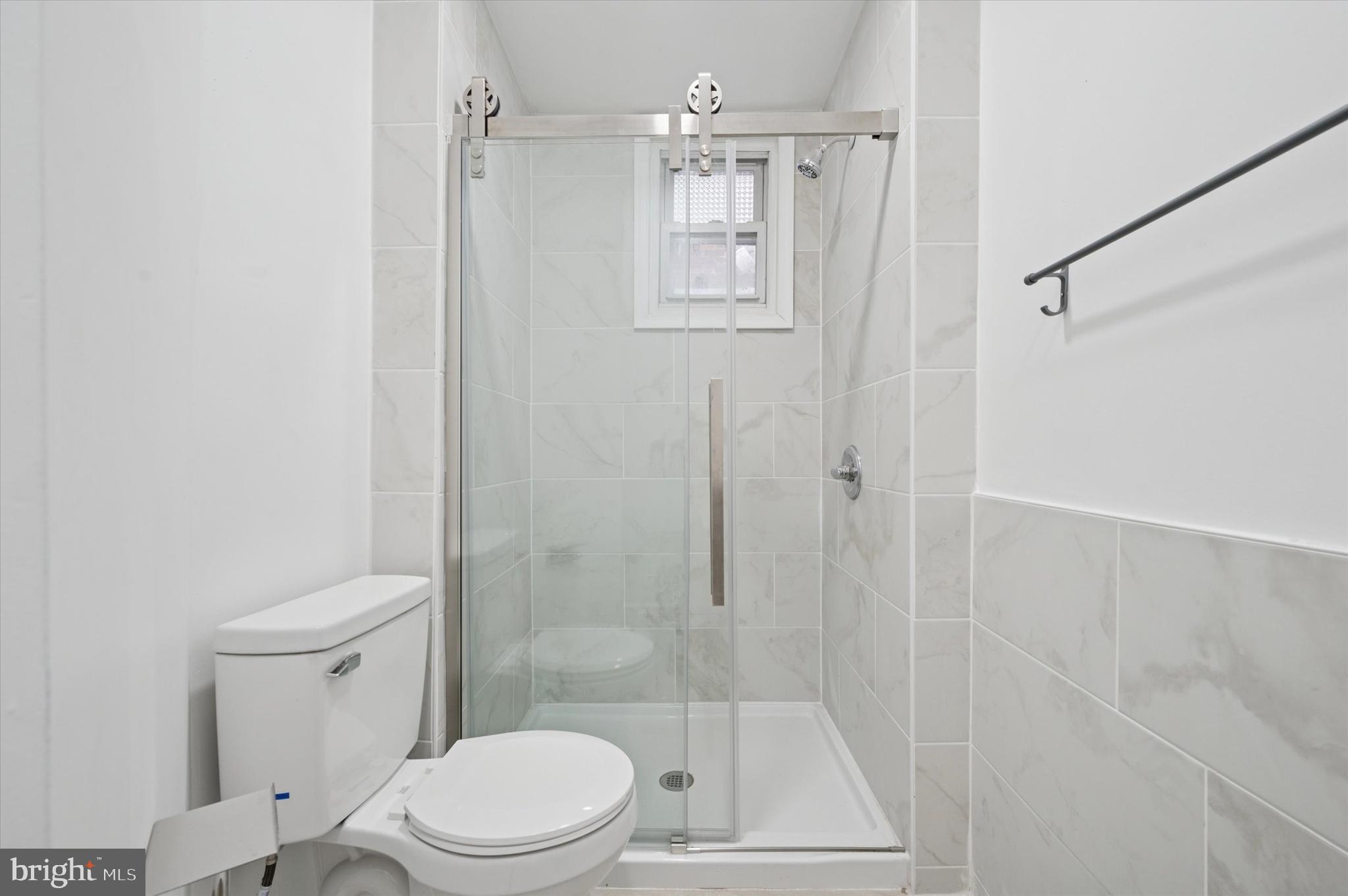 249 South 44th Street, Unit 4 Philadelphia, PA 19104 - Photo 25 of 25 a white toilet sitting next to a bathroom sink
